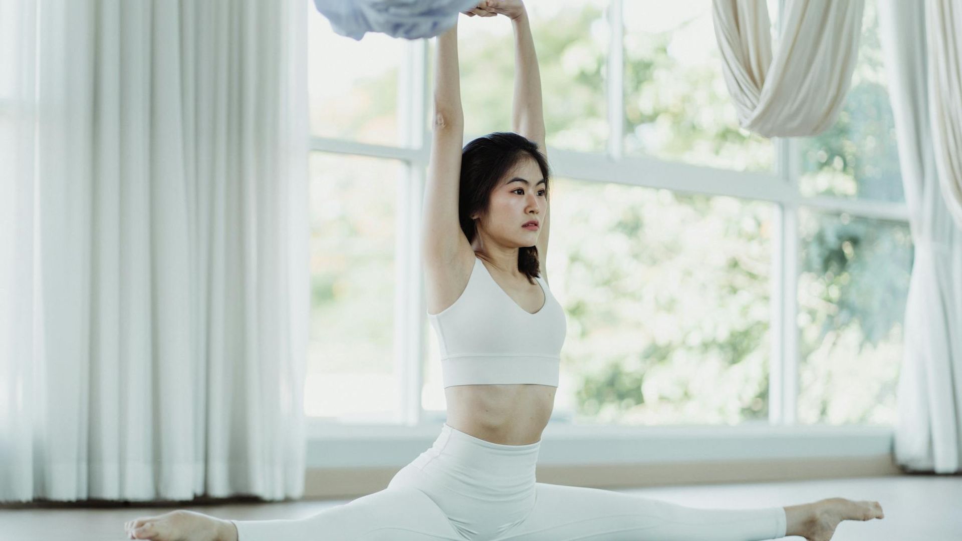 Serene yoga studio with natural light and bamboo mats